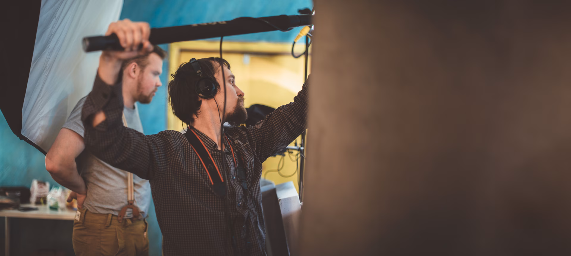 Technician reaching up to adjust equipment during a site set-up