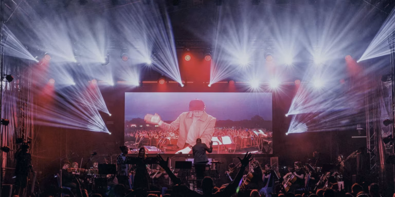Concert stage with large lighting show, LED screen and orchestra