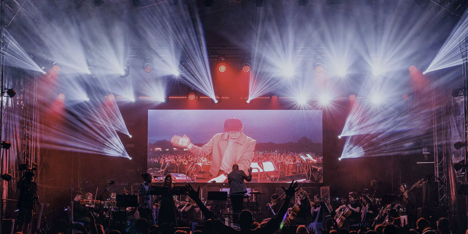 Concert stage with large lighting show, LED screen and orchestra