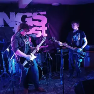 2 young men playing guitars