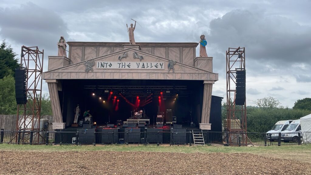 Festival stage with a decorative castle-style frontage and speaker towers at Nozstock