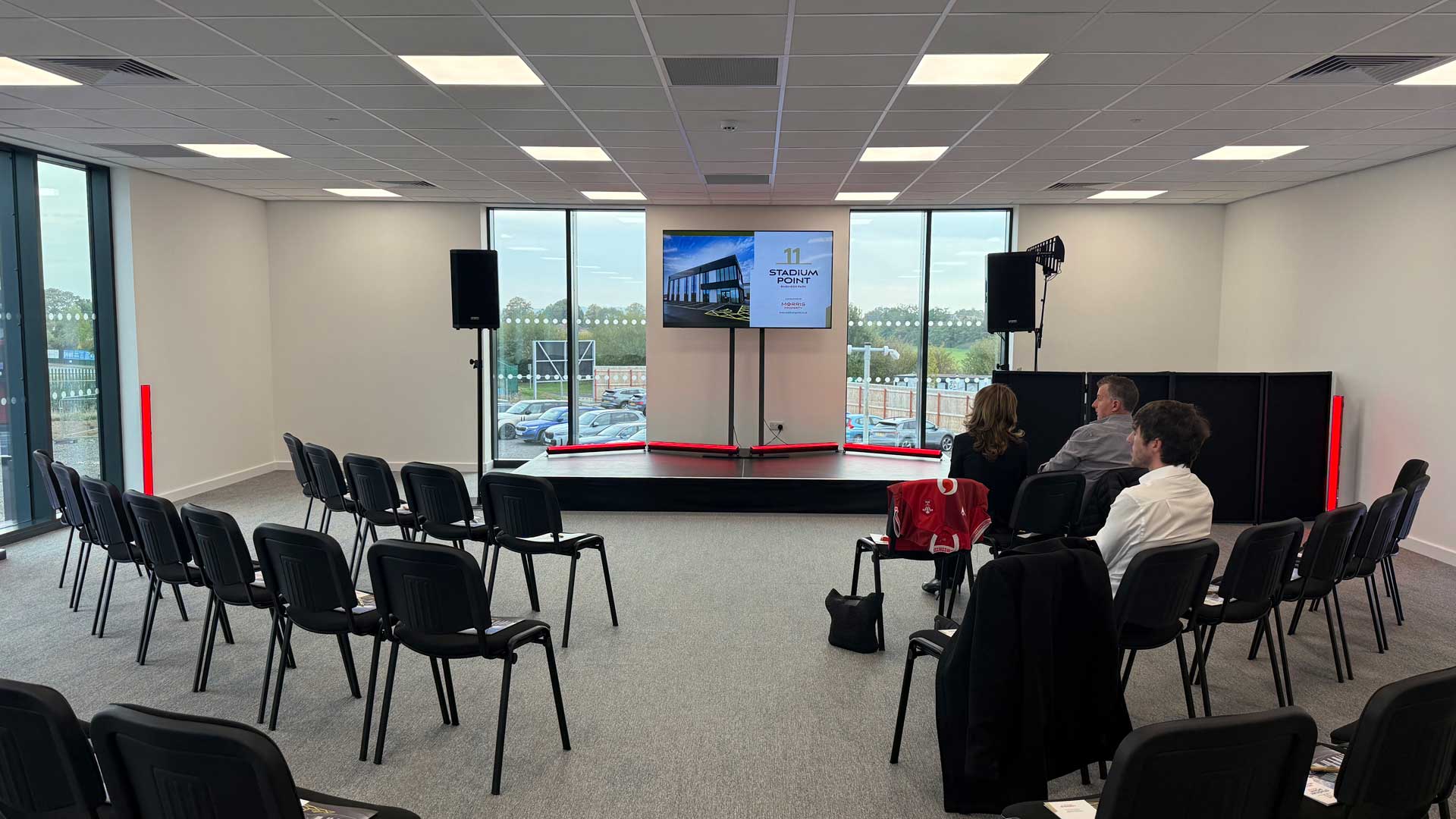 Stage, large LED TV and sound system setup for a corporate event