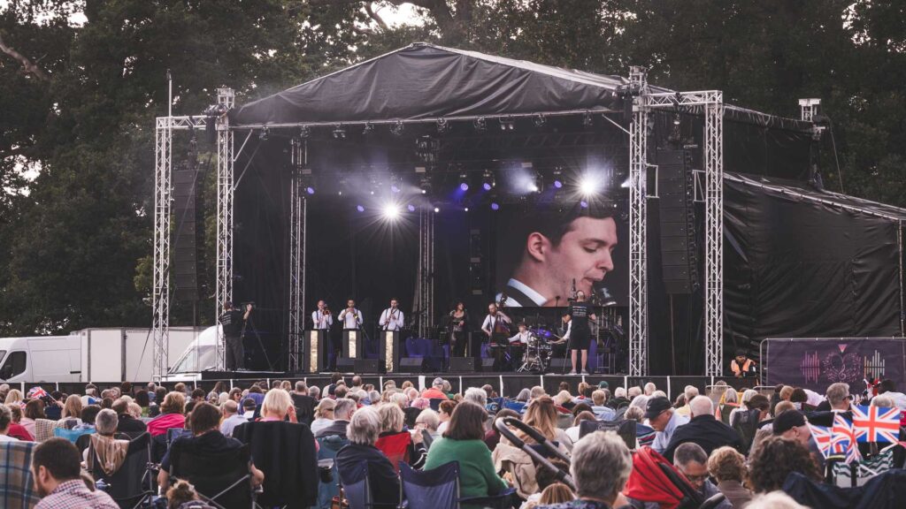 Attingham June 2025 Jazz Band Performing on Large Outdoor Stage with audience watchign