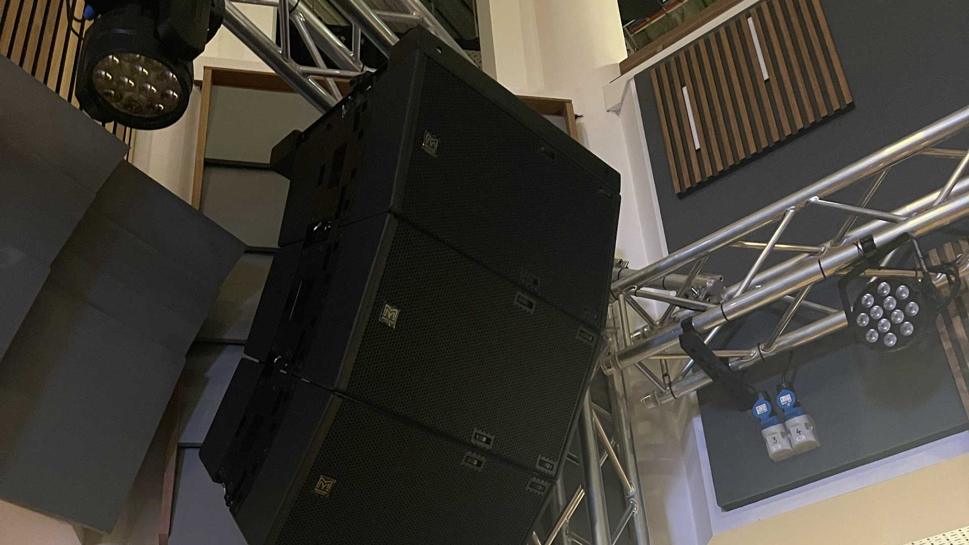Curved source array sound system installed in live music space