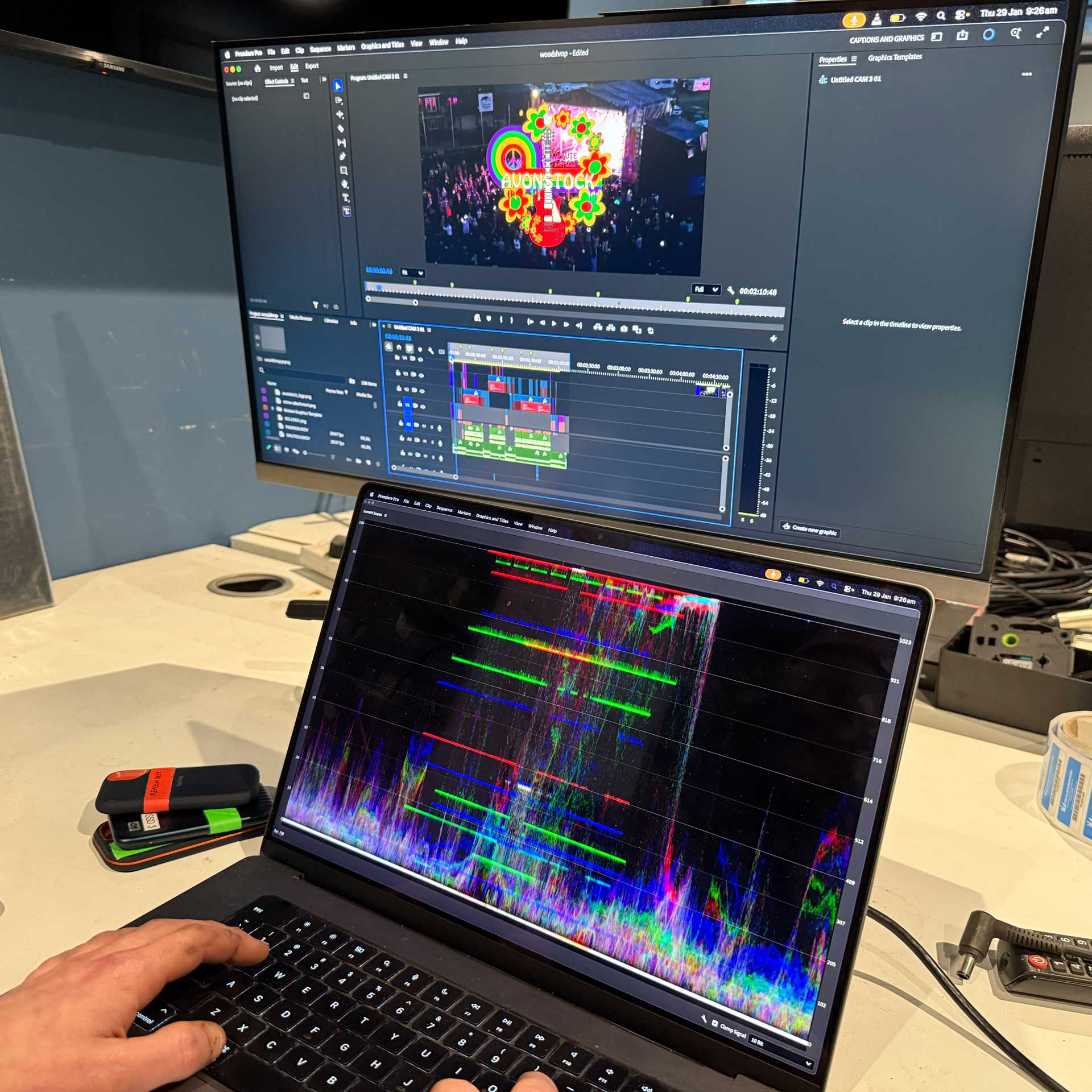 Laptop connected to external monitor showing video editing software
