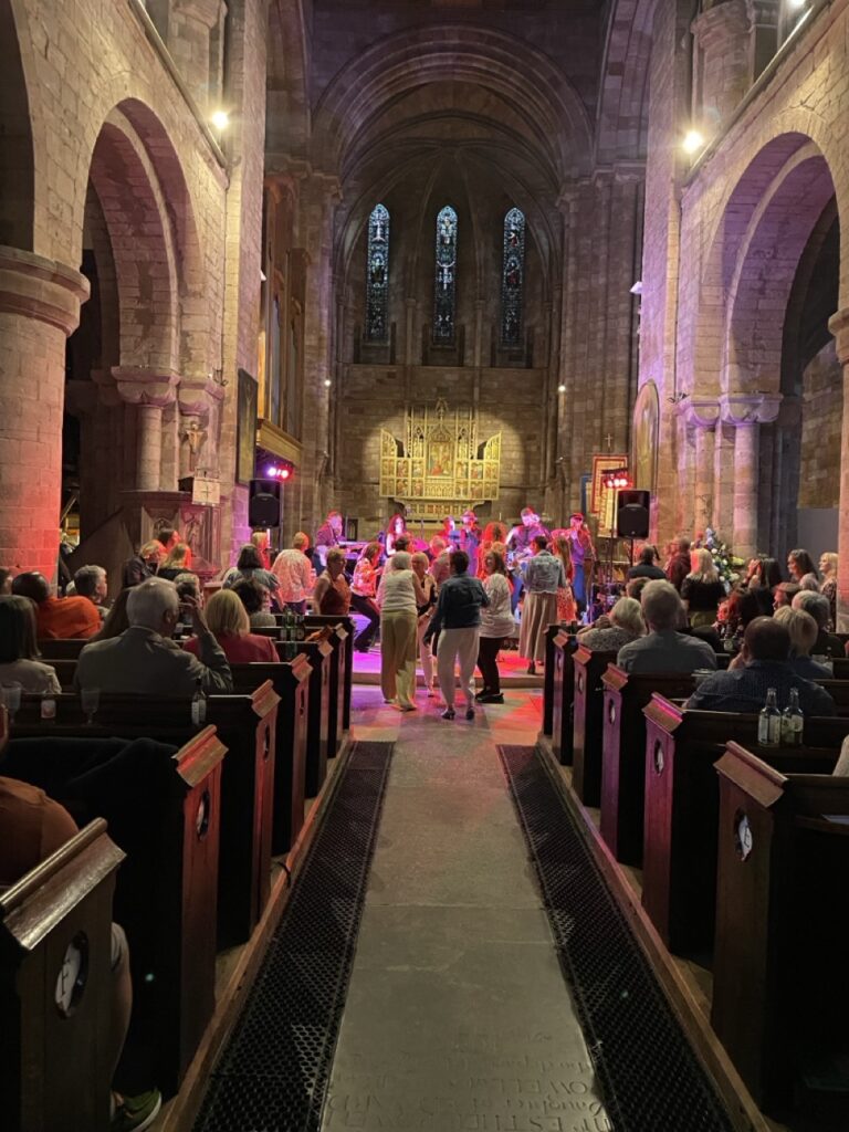 Hot Jazz Biscuits band playing live to an audience of people at Shrewsbury Abbey