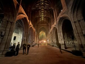 Chester cathedral set-up with stage at one end and speakers set-up along the length