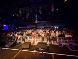 View from the front of the stage looking out at a large audience in Norwich
