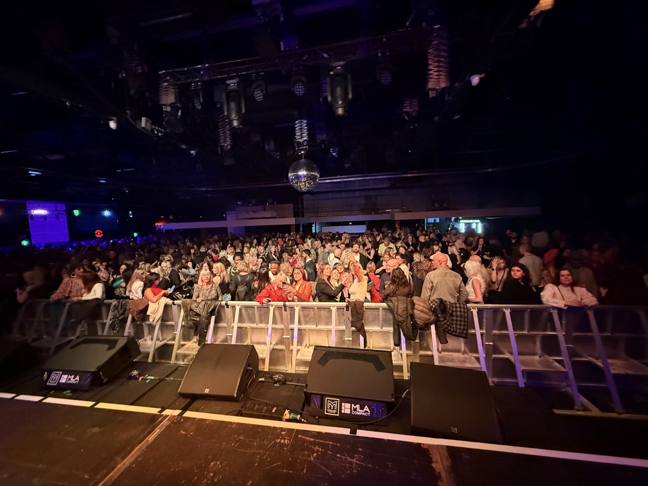 View from the front of the stage looking out at a large audience in Norwich