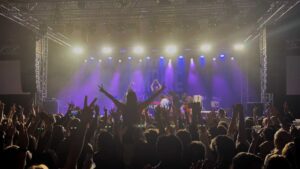 Band playing on stage at the HMV Empire in Coventry with an audience dancing in front