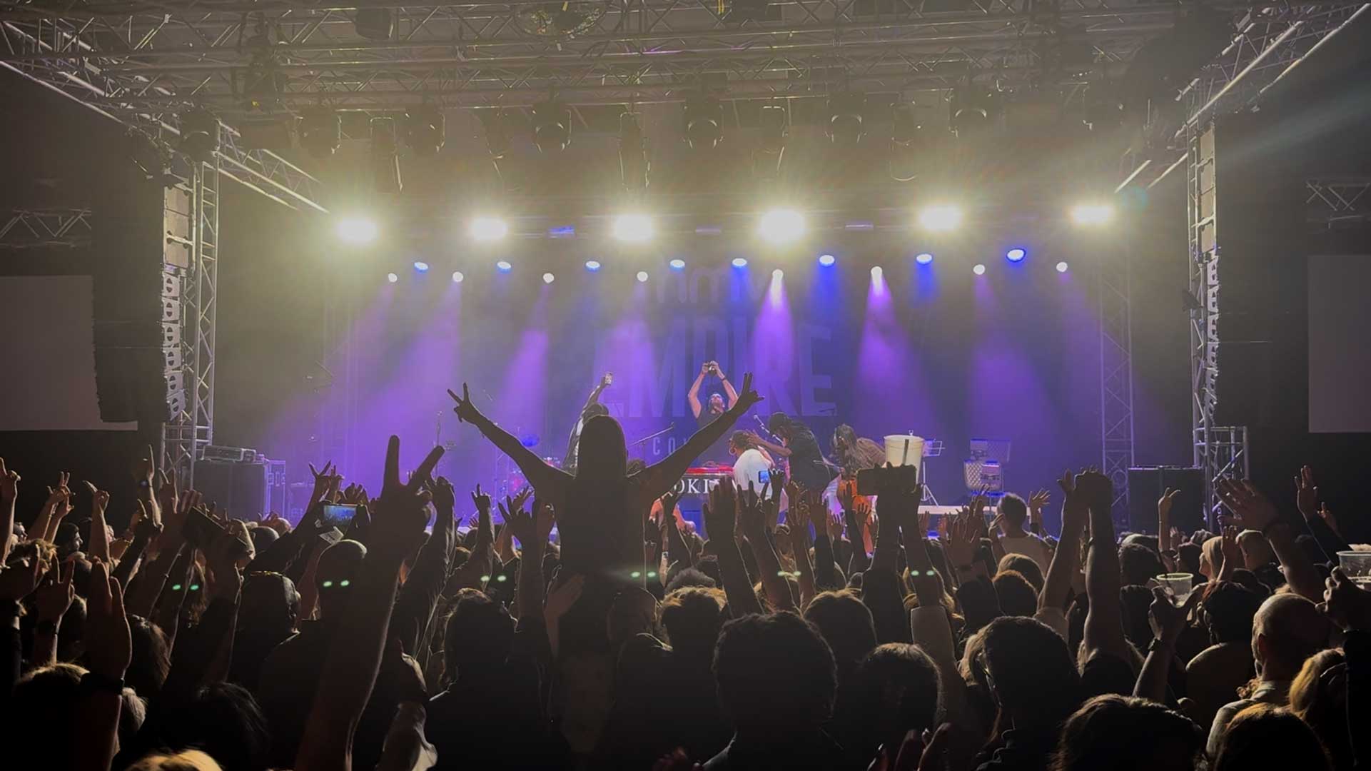 Band playing on stage at the HMV Empire in Coventry with an audience dancing in front