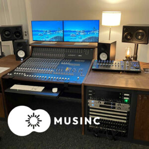 Studio mixing console with monitors and rack equipment in a recording studio