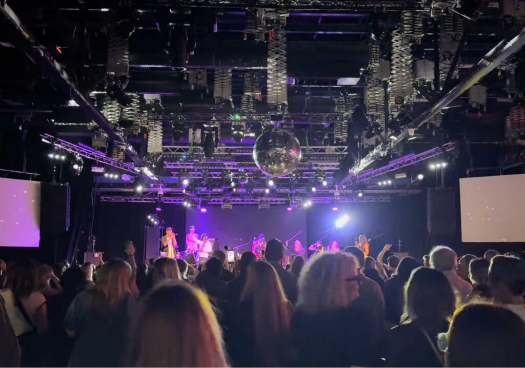 Nightclub dance floor with a lighting truss above the crowd