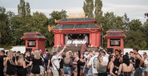Red pagoda-style festival stage with the crowd in front